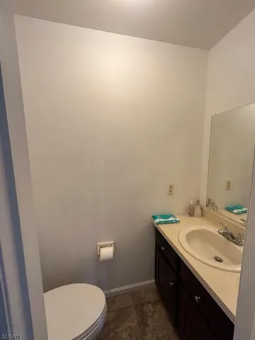 a bathroom with a sink a toilet and vanity