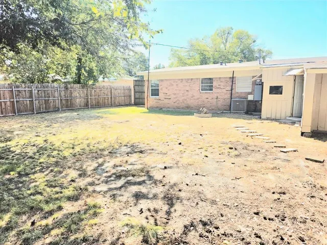 a view of a backyard of the house