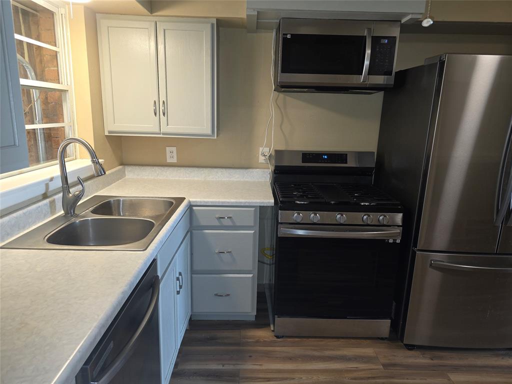 1513 Arcady Lane Irving, TX 75061 - Photo 3 of 20 a kitchen with a refrigerator stove and sink