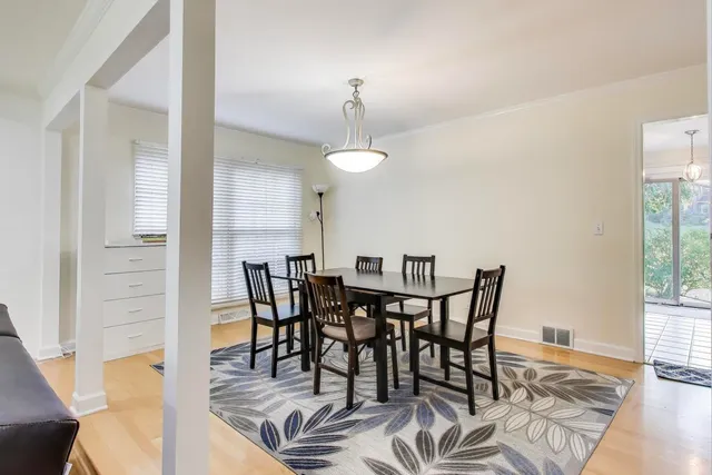 a view of a dining room with furniture and wooden floor
