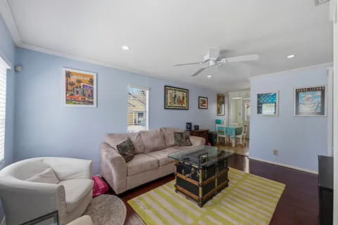 a living room with furniture and a wooden floor