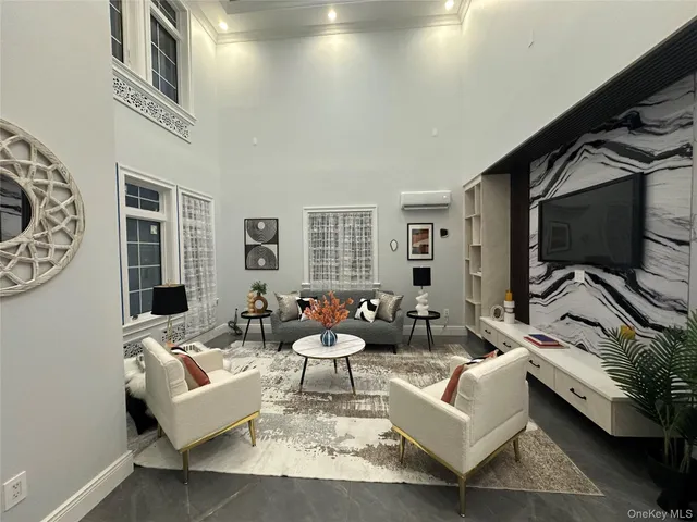 a living room with furniture and a chandelier