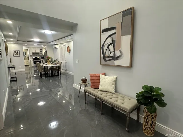 an empty room with a wooden floor and a painting on the wall