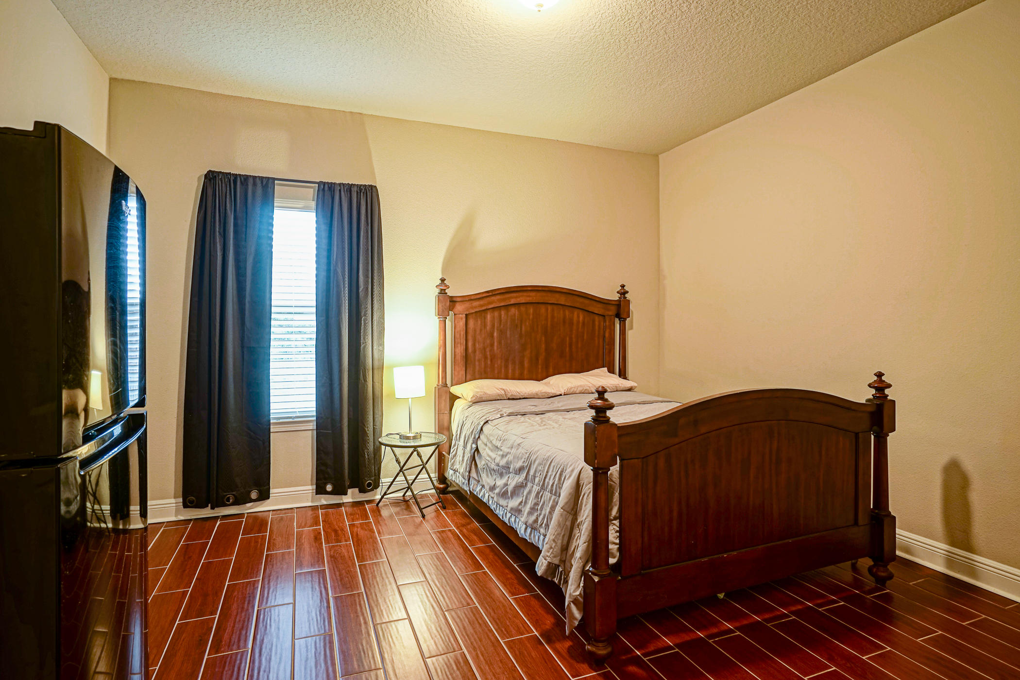 631 Red Fern Road Crestview, FL 32536 - Photo 16 of 23 a bedroom with a bed and wooden floor