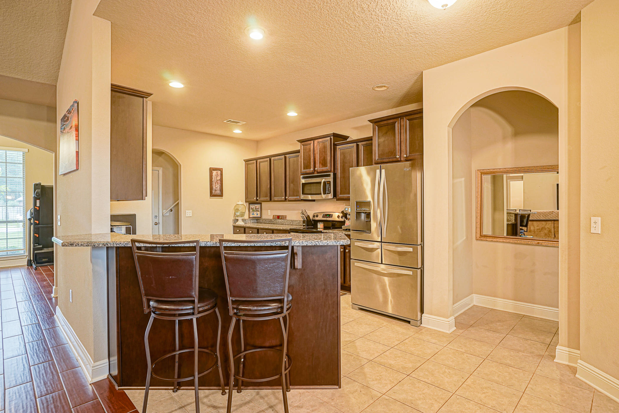631 Red Fern Road Crestview, FL 32536 - Photo 5 of 23 a kitchen with stainless steel appliances kitchen island granite countertop a refrigerator and cabinets