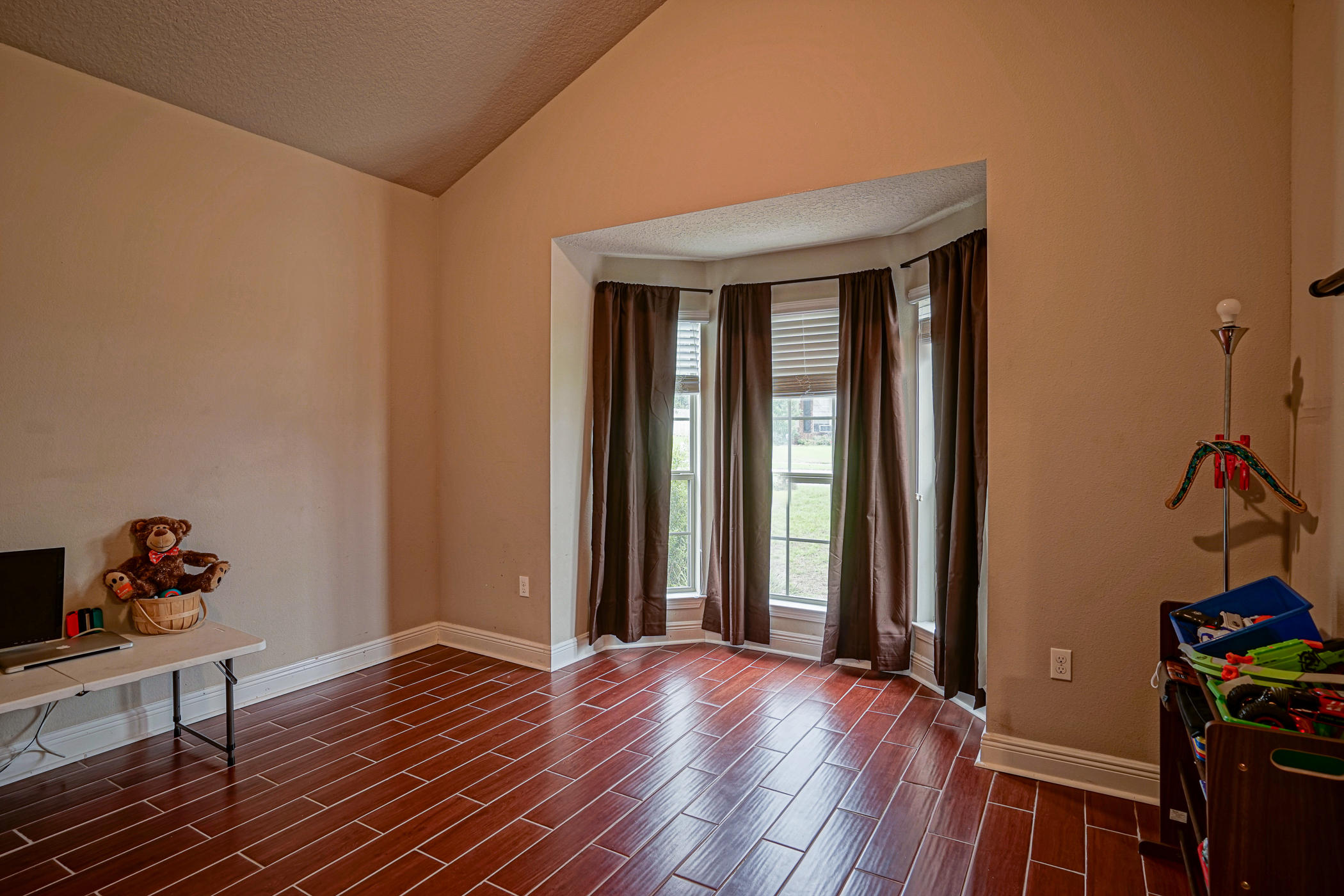 631 Red Fern Road Crestview, FL 32536 - Photo 7 of 23 a view of a room that has wooden floor and furniture