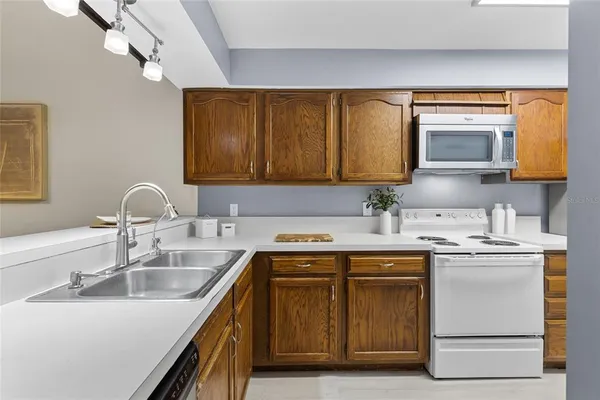 a kitchen with stainless steel appliances granite countertop a sink stove and microwave