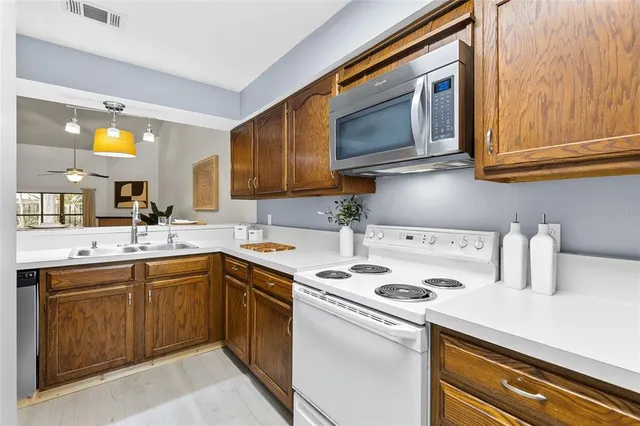 a kitchen with a sink cabinets and a wooden floor