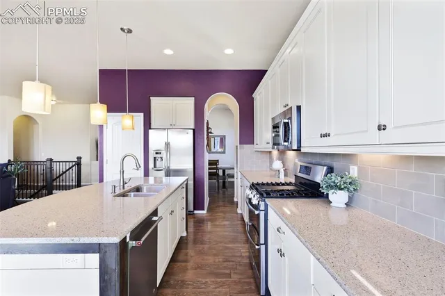 a kitchen with stainless steel appliances granite countertop a sink and cabinets