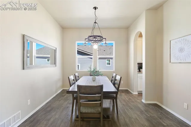 a view of a dining room with a table and chairs