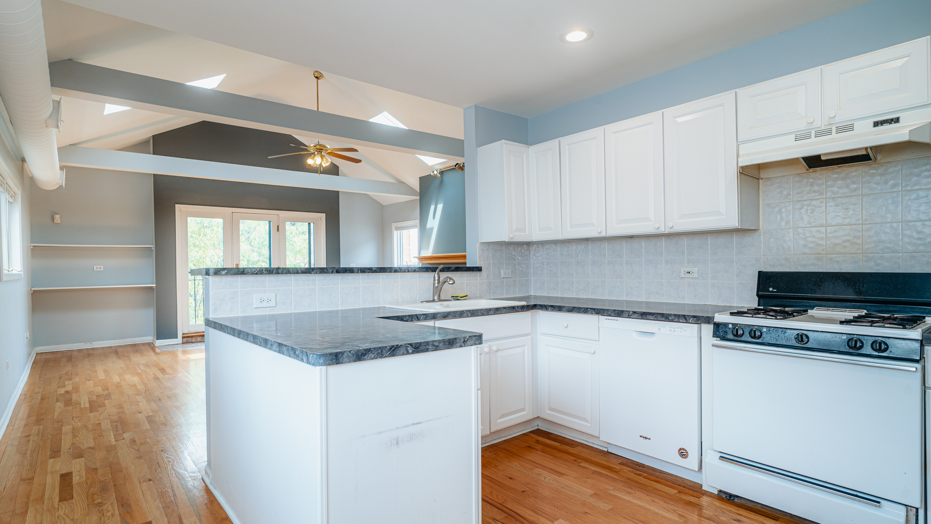 2319 West Harrison Street, Unit 4 Chicago, IL 60612 - Photo 11 of 25 a kitchen with a sink stove and cabinets