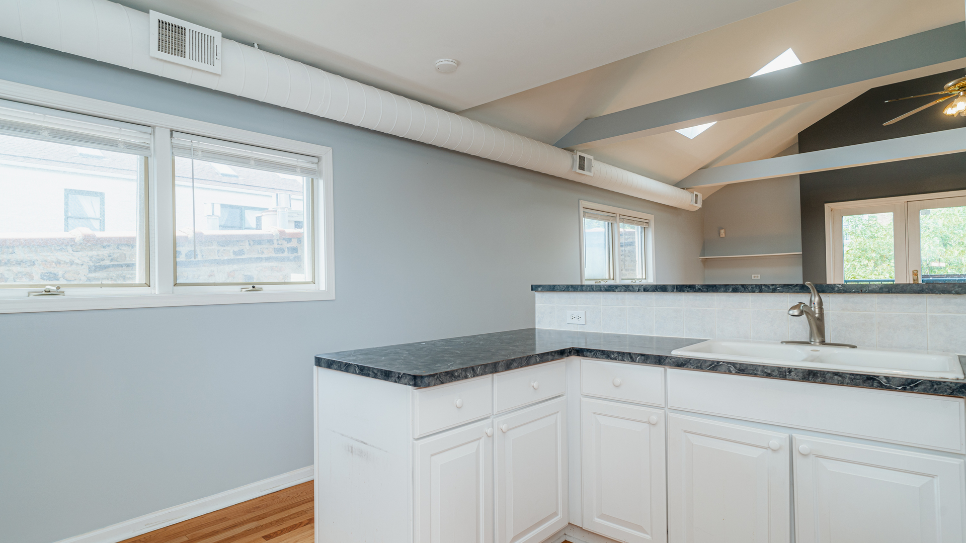2319 West Harrison Street, Unit 4 Chicago, IL 60612 - Photo 12 of 25 a kitchen with a sink cabinets and a window