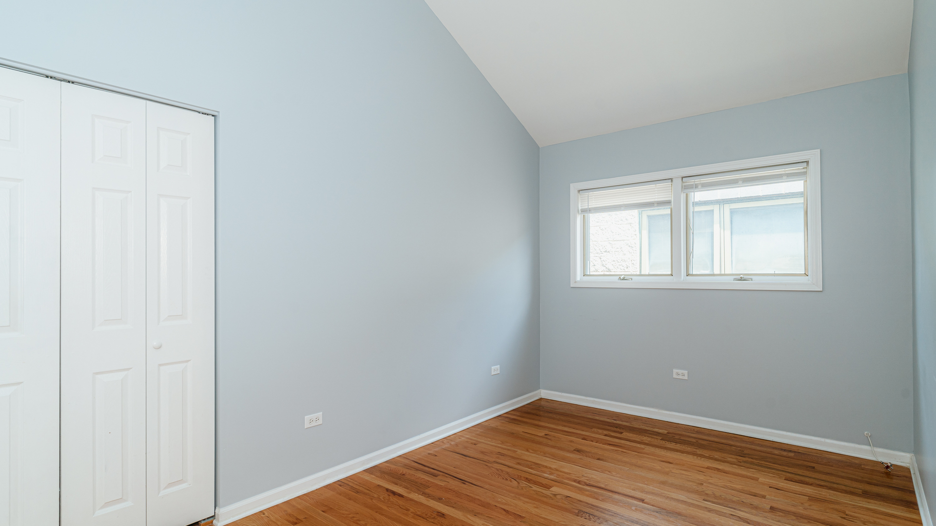 2319 West Harrison Street, Unit 4 Chicago, IL 60612 - Photo 13 of 25 a view of an empty room with wooden floor and a window