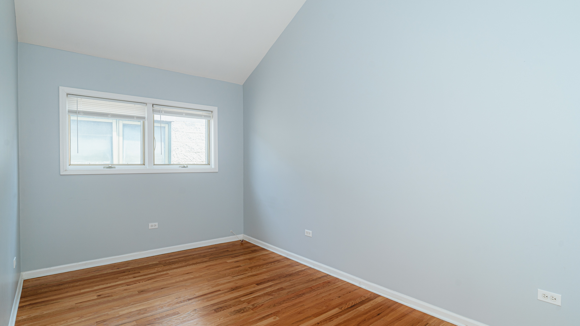 2319 West Harrison Street, Unit 4 Chicago, IL 60612 - Photo 14 of 25 a view of an empty room with wooden floor and a window
