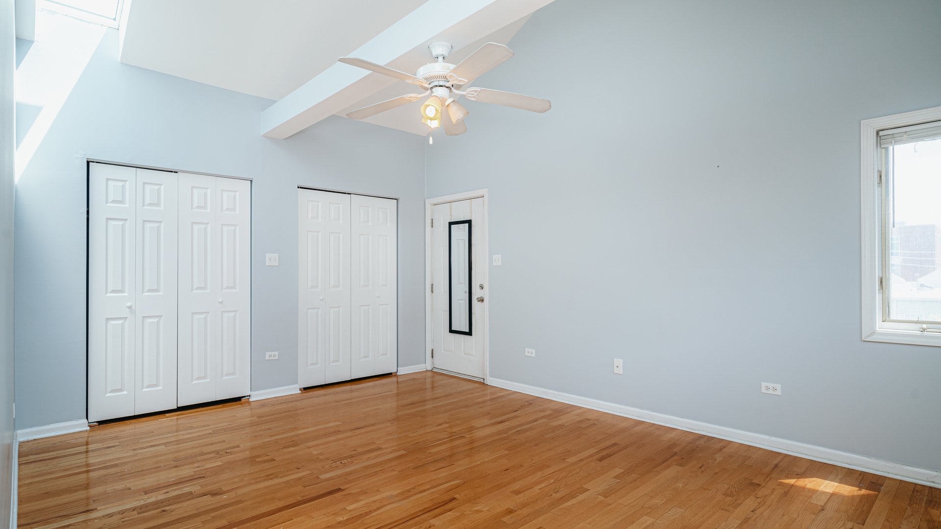 2319 West Harrison Street, Unit 4 Chicago, IL 60612 - Photo 16 of 25 a view of a room with wooden floor and ceiling fan