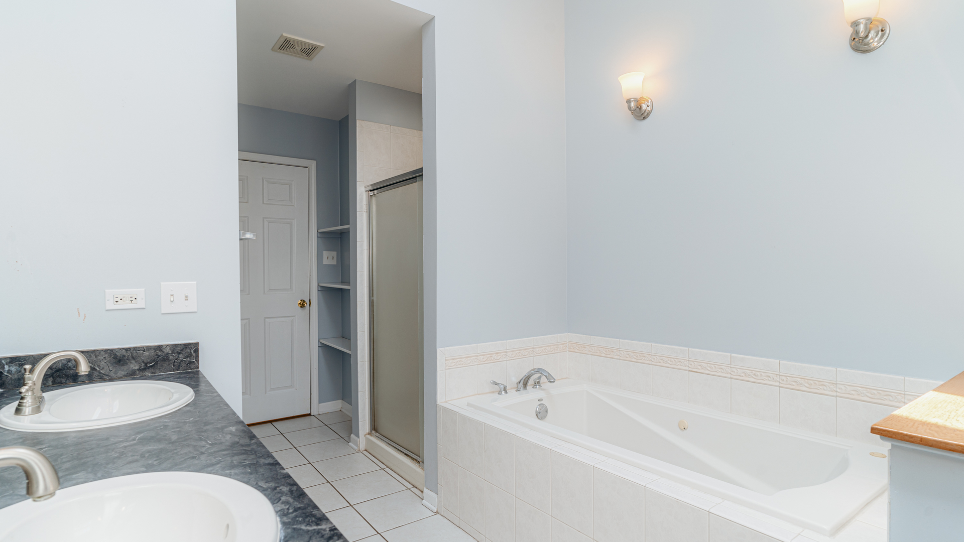 2319 West Harrison Street, Unit 4 Chicago, IL 60612 - Photo 17 of 25 a spacious bathroom with a granite countertop sink and a bathtub