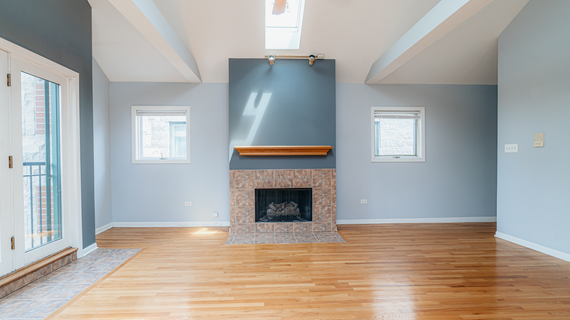 2319 West Harrison Street, Unit 4 Chicago, IL 60612 - Photo 4 of 25 a view of an empty room with wooden floor and a window