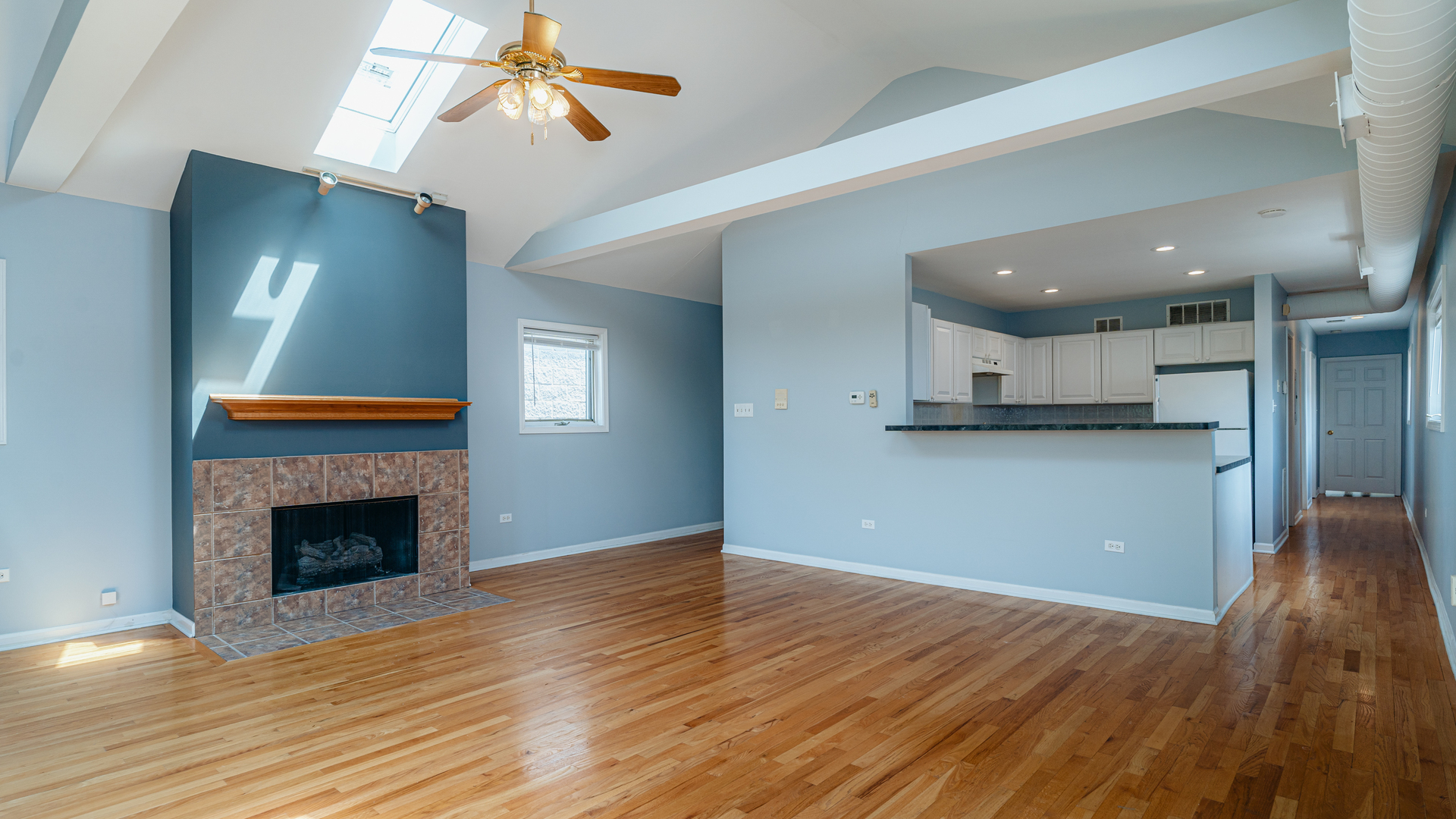 2319 West Harrison Street, Unit 4 Chicago, IL 60612 - Photo 5 of 25 a view of a room with wooden floor and a fireplace
