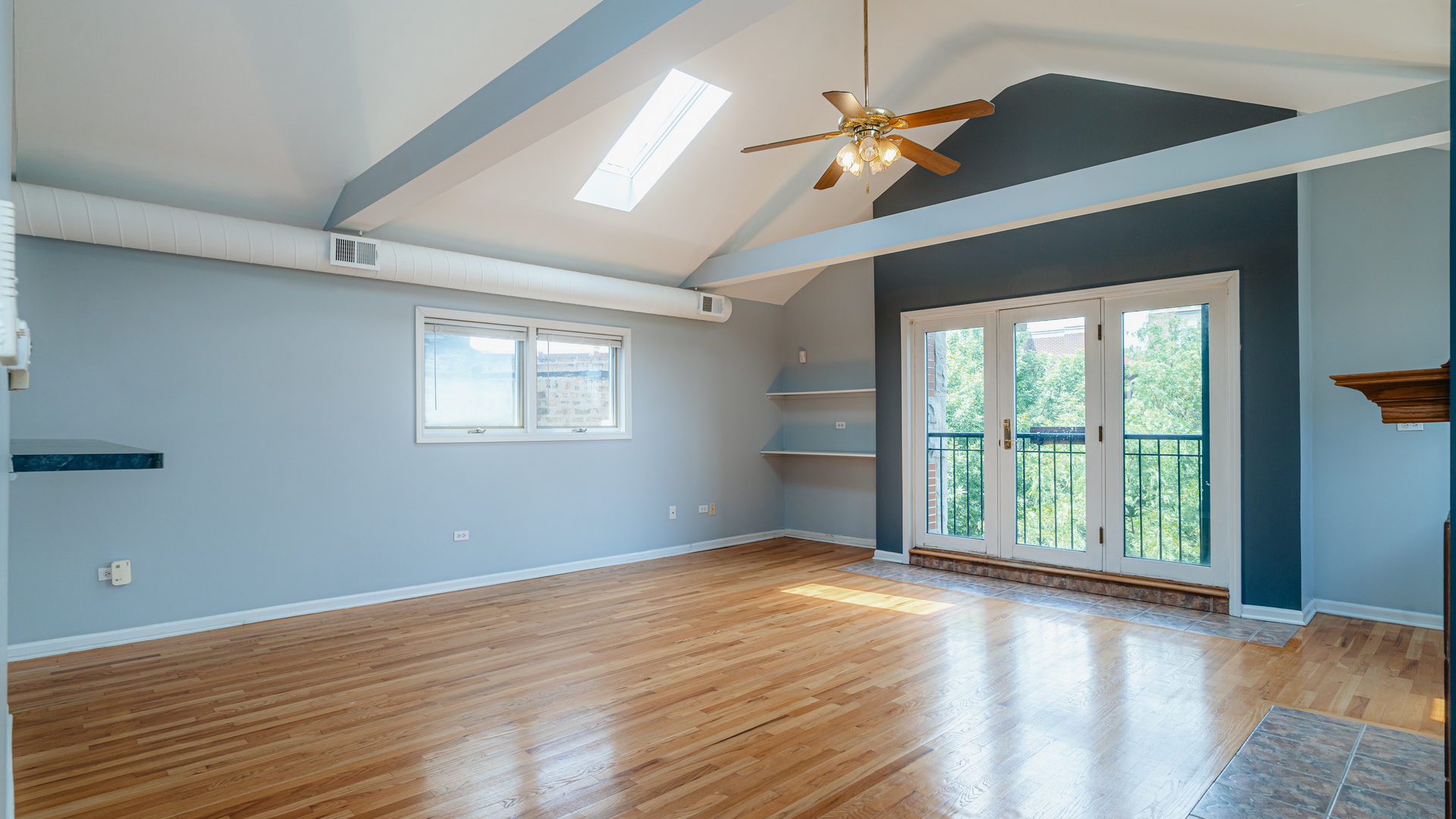 2319 West Harrison Street, Unit 4 Chicago, IL 60612 - Photo 7 of 25 a view of an empty room with wooden floor and a window