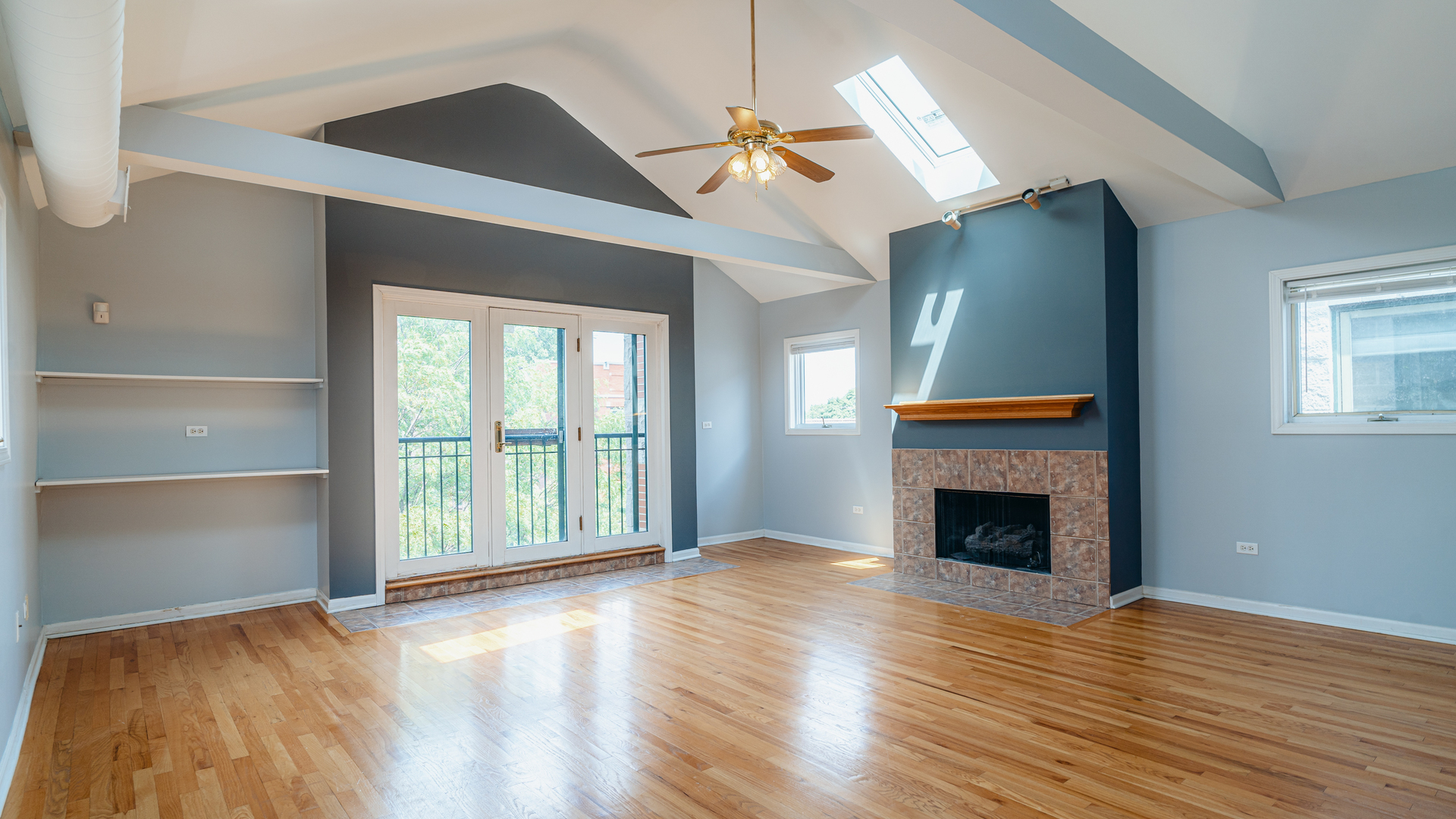 2319 West Harrison Street, Unit 4 Chicago, IL 60612 - Photo 8 of 25 a view of an empty room with wooden floor fireplace and a window