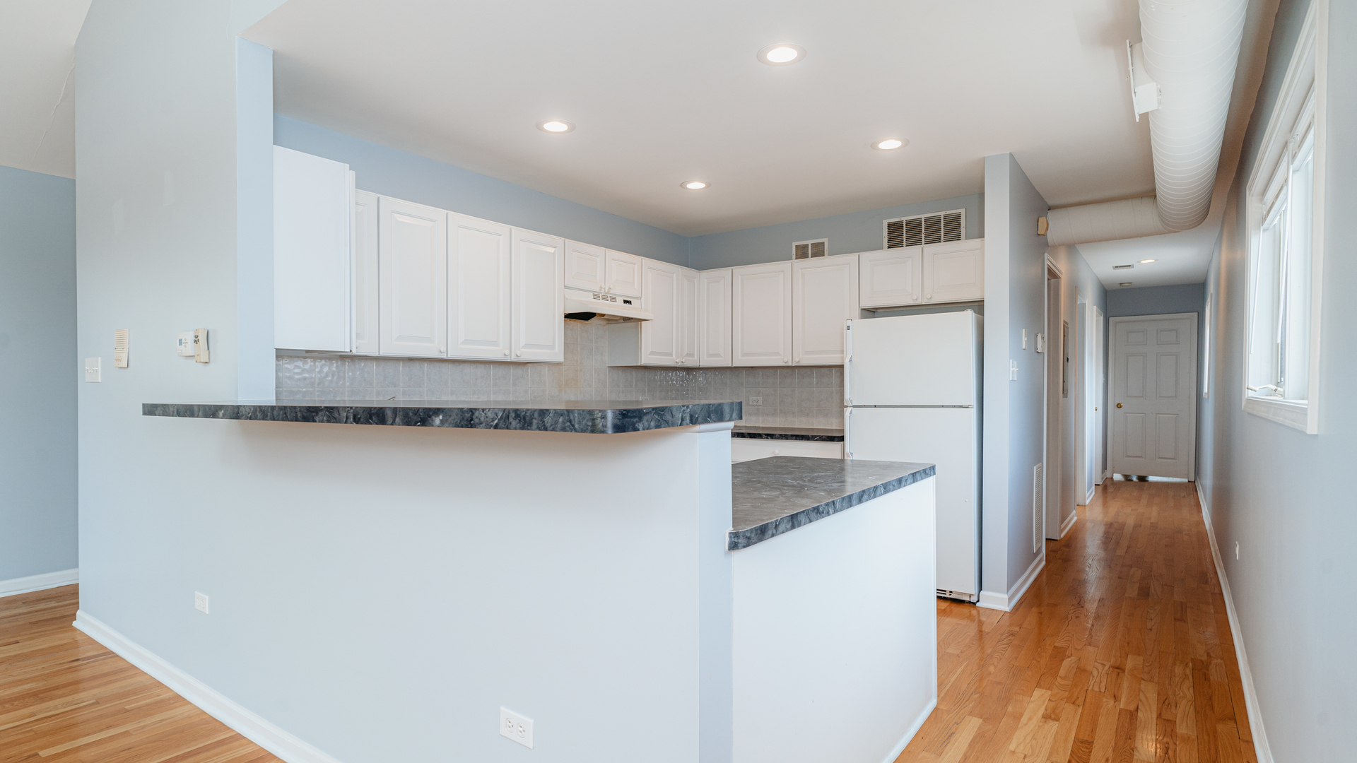 2319 West Harrison Street, Unit 4 Chicago, IL 60612 - Photo 10 of 25 a kitchen with granite countertop a refrigerator and a sink