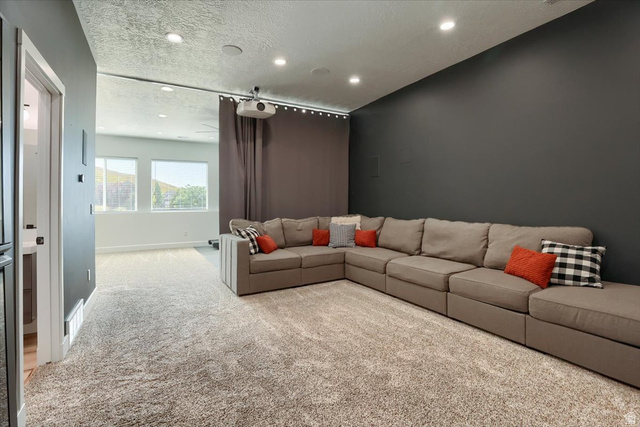 828 South Deer Road Tooele, UT 84074 - Photo 19 of 51 Media room featuring a projector, recessed lighting, and a large projection wall