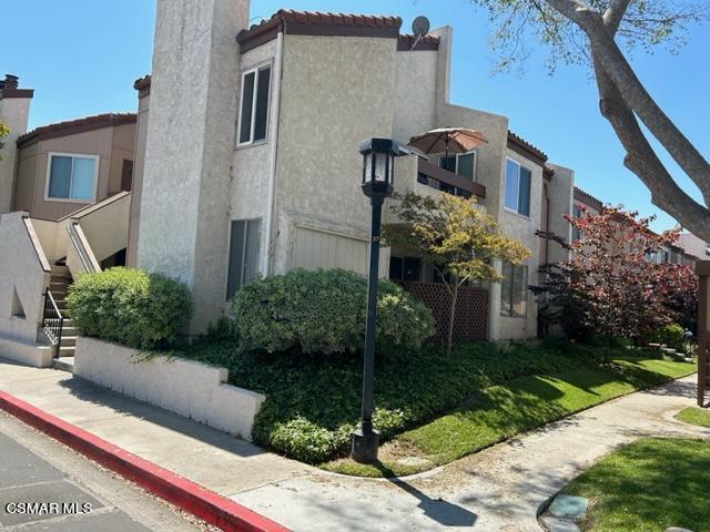 1724 Sinaloa Road, Unit 125 Simi Valley, CA 93065 - Photo 1 of 17 a front view of a house with a garden