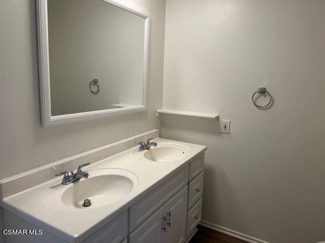 1724 Sinaloa Road, Unit 125 Simi Valley, CA 93065 - Photo 12 of 17 a bathroom with a sink and a mirror