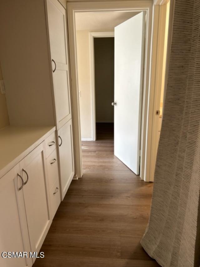1724 Sinaloa Road, Unit 125 Simi Valley, CA 93065 - Photo 6 of 17 a view of a hallway with wooden floor and staircase