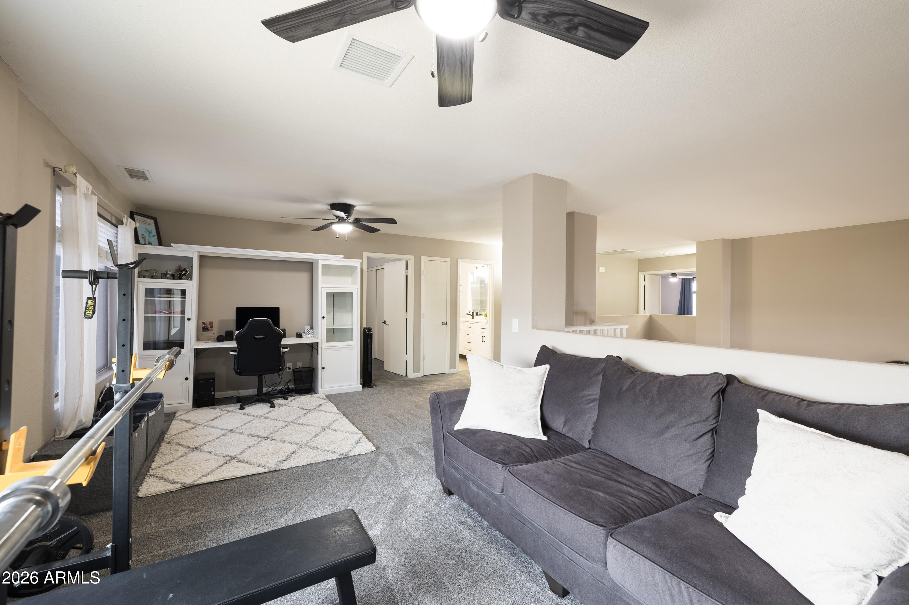 6407 West Saddlehorn Road Phoenix, AZ 85083 - Photo 29 of 41 a living room with furniture ceiling fan and a rug