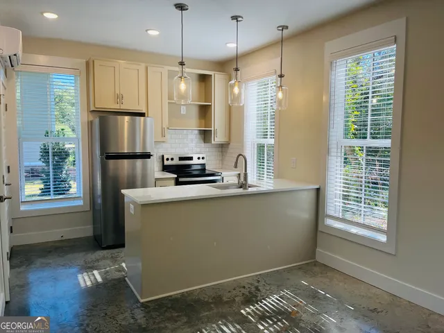 a kitchen with refrigerator and window