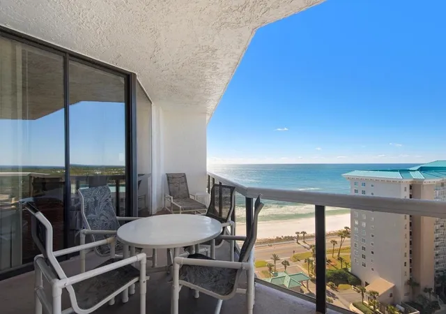 a balcony with table and chairs