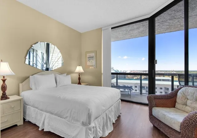 a bedroom with a large bed and a large window