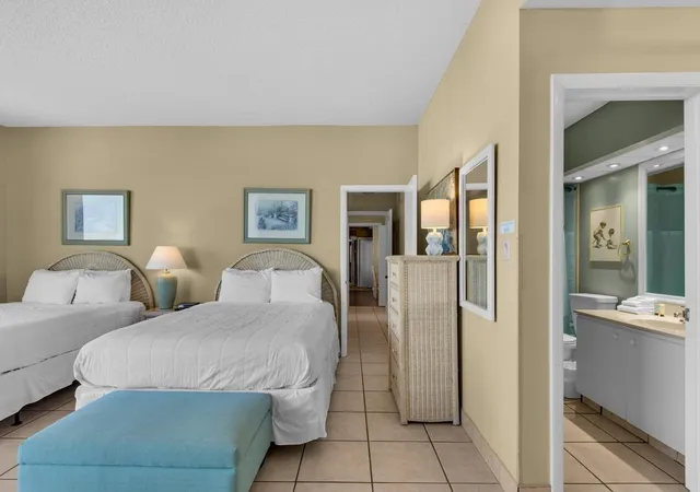 a spacious bedroom with two beds and painted walls