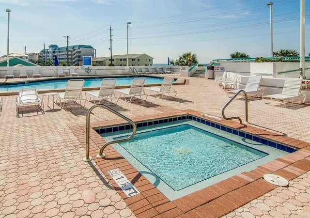 a view of a swimming pool with a lounge chairs