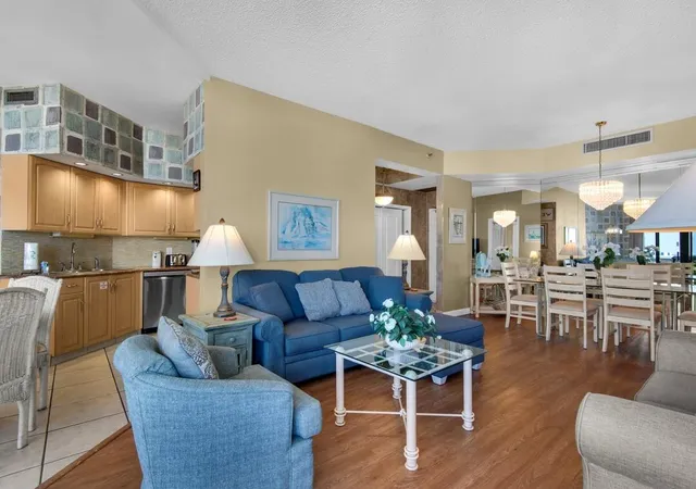 a living room with furniture kitchen view and a table