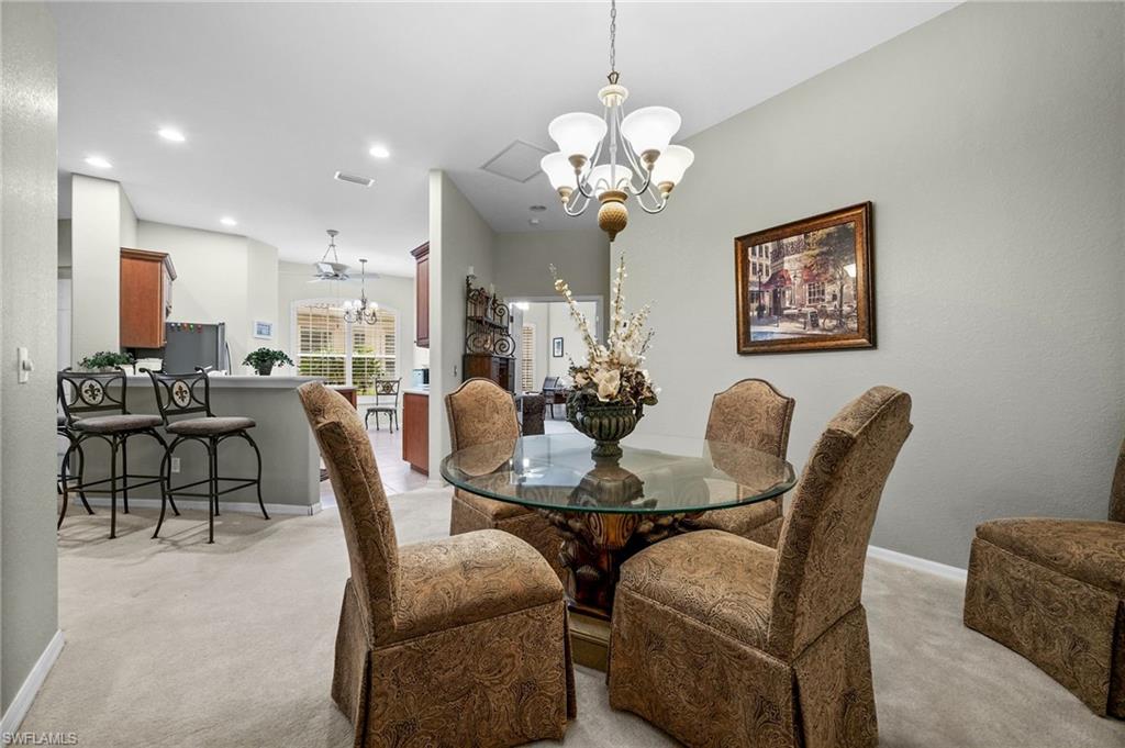 28531-f B F B Fowler Court Bonita Springs, FL 34135 - Photo 12 of 34 a view of a dining room with furniture and chandelier