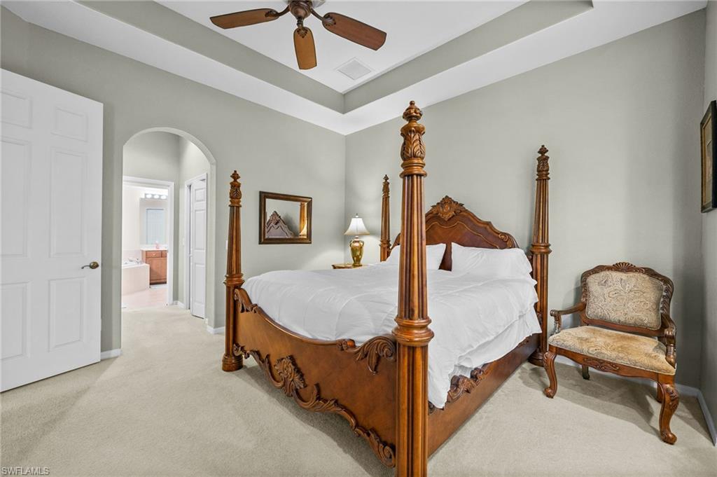 28531-f B F B Fowler Court Bonita Springs, FL 34135 - Photo 15 of 34 a bedroom with a bed and a chandelier