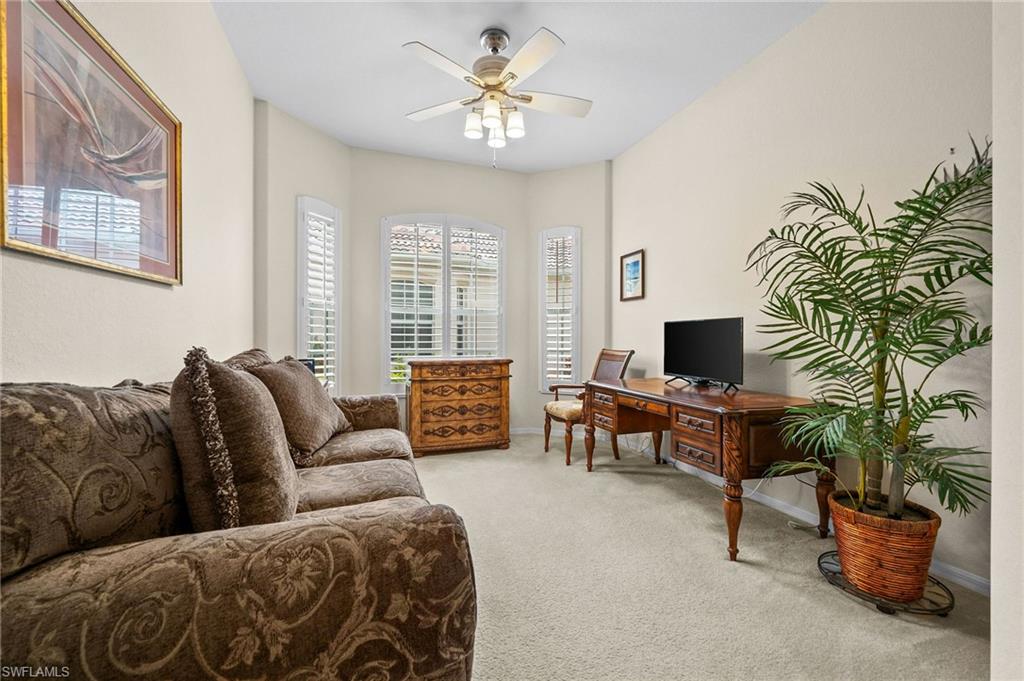 28531-f B F B Fowler Court Bonita Springs, FL 34135 - Photo 18 of 34 a living room with furniture and a flat screen tv