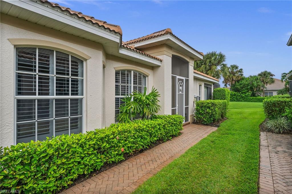 28531-f B F B Fowler Court Bonita Springs, FL 34135 - Photo 2 of 34 a view of a house with brick walls and a yard with plants