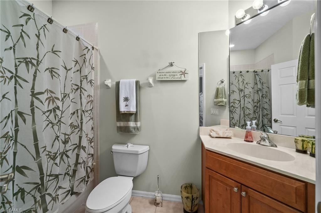 28531-f B F B Fowler Court Bonita Springs, FL 34135 - Photo 21 of 34 a bathroom with a toilet sink and mirror