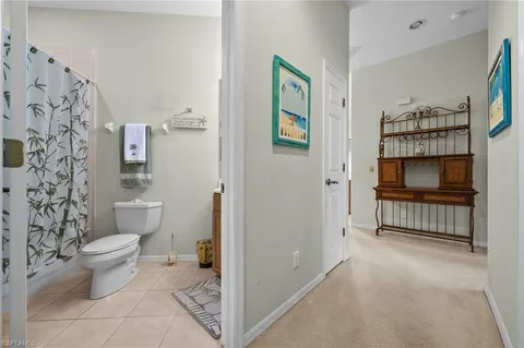 a bathroom with a toilet and a shower curtain