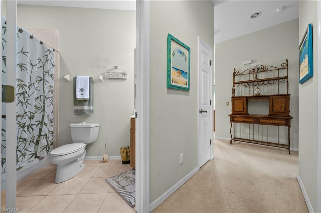 28531-f B F B Fowler Court Bonita Springs, FL 34135 - Photo 22 of 34 a bathroom with a toilet and a shower curtain