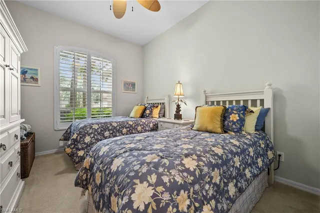 a large bed sitting in a bedroom next to a window