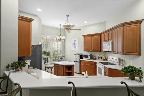 a kitchen with a table chairs stove and microwave