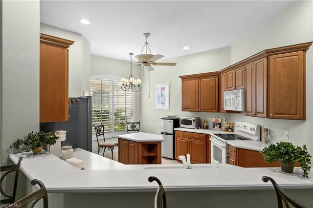 a kitchen with a table chairs stove and microwave