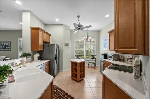 a kitchen with a sink dishwasher a refrigerator and cabinets