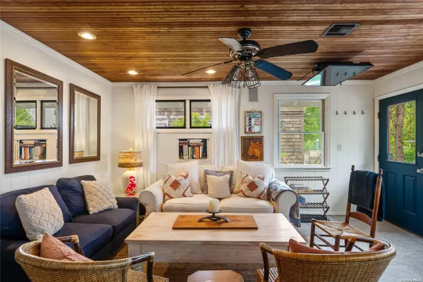 a living room with furniture and a chandelier