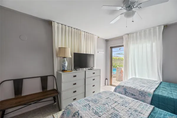 a bedroom with a bed and a flat screen television