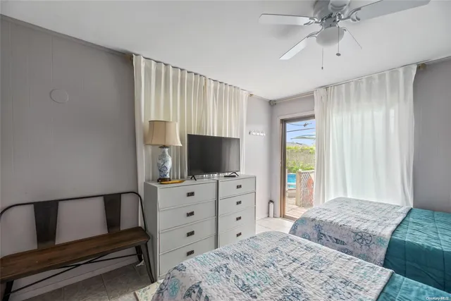 a bedroom with a bed and a flat screen television